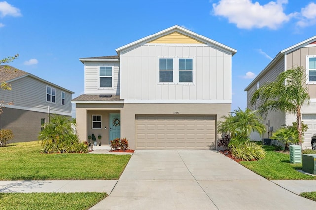 12856 French Market Dr, Riverview, FL 33579 - view of front of house with concrete driveway, an attached garage, board and batten siding, central AC unit, and a front lawn