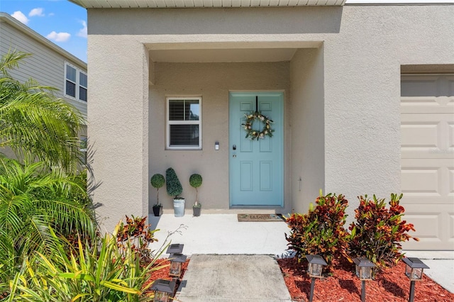 12856 French Market Dr, Riverview, FL 33579 - entrance to property featuring stucco siding and a garage
