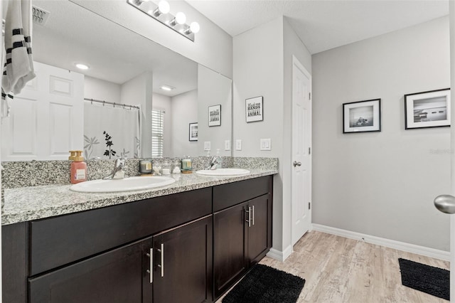 12856 French Market Dr, Riverview, FL 33579 - full bathroom featuring double vanity, visible vents, wood finished floors, and a sink