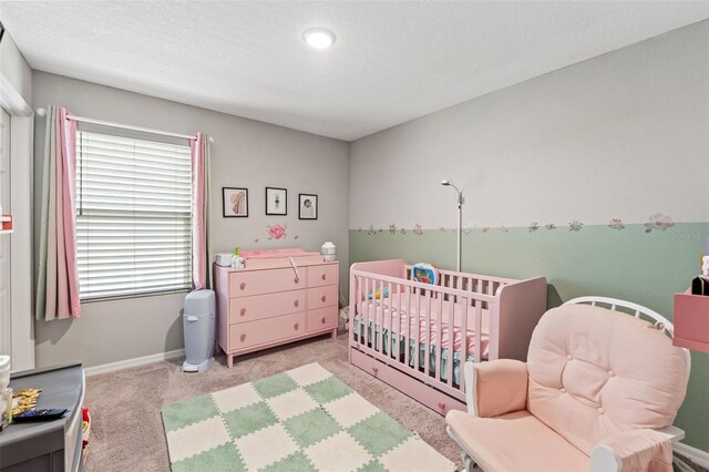 12856 French Market Dr, Riverview, FL 33579 - carpeted bedroom featuring baseboards, a crib, and a textured ceiling