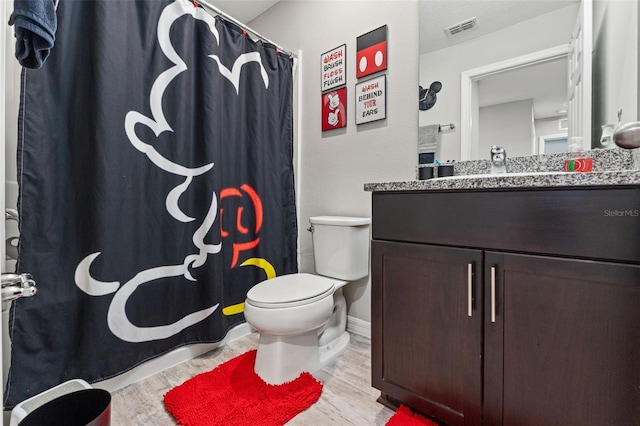12856 French Market Dr, Riverview, FL 33579 - full bath with a shower with curtain, vanity, toilet, visible vents, and wood finished floors