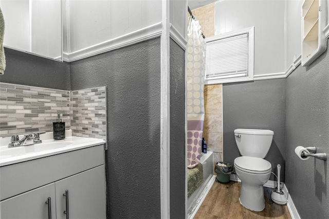 1134 9th Ave S, Saint Petersburg, FL 33705 - full bath with vanity, toilet, a textured wall, shower / bath combo with shower curtain, and wood finished floors