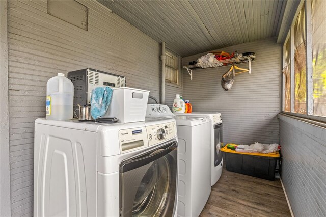 1134 9th Ave S, Saint Petersburg, FL 33705 - washroom featuring wood finished floors, laundry area, and washer and dryer