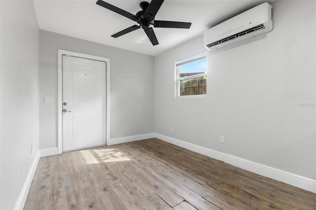 1134 9th Ave S, Saint Petersburg, FL 33705 - unfurnished room featuring baseboards, ceiling fan, wood finished floors, and an AC wall unit