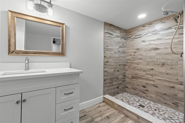 1134 9th Ave S, Saint Petersburg, FL 33705 - full bath with vanity, recessed lighting, baseboards, tiled shower, and wood finished floors