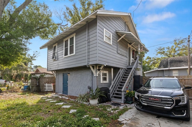 1134 9th Ave S, Saint Petersburg, FL 33705 - view of front of property with stone siding, fence, and stairway
