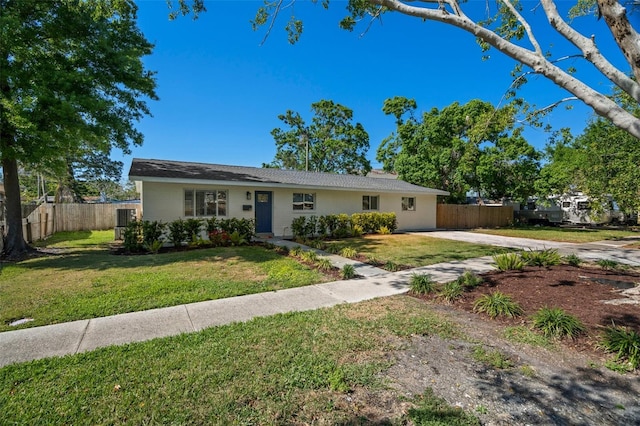 view of front of house with a front lawn and fence