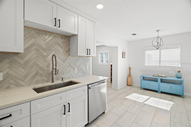 kitchen with tasteful backsplash, visible vents, white cabinets, a sink, and stainless steel dishwasher