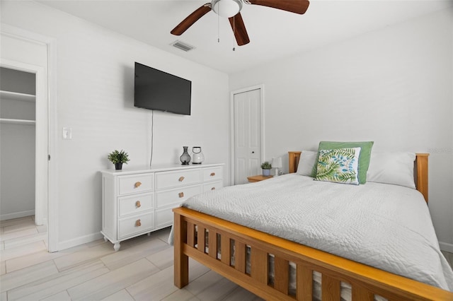bedroom with visible vents, baseboards, a ceiling fan, and a closet