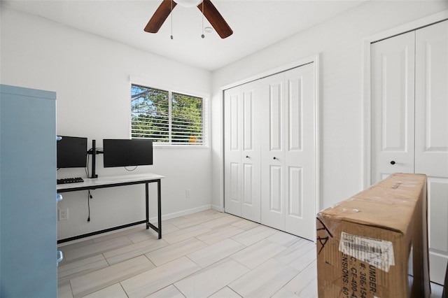 office area with baseboards and ceiling fan