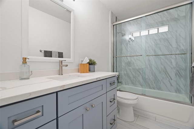 full bath featuring toilet, vanity, and enclosed tub / shower combo