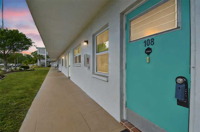 1900 59th Ave N Unit 108, Saint Petersburg, FL 33714 - entrance to property with stucco siding and a yard