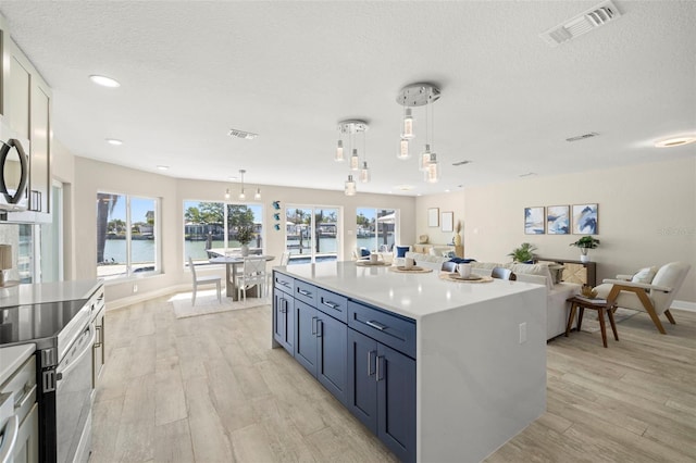 kitchen with visible vents, light countertops, and light wood-style flooring