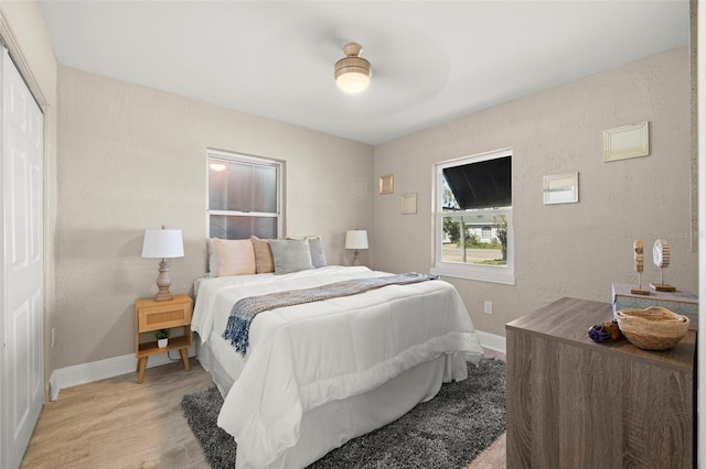 bedroom featuring baseboards and light wood-style floors