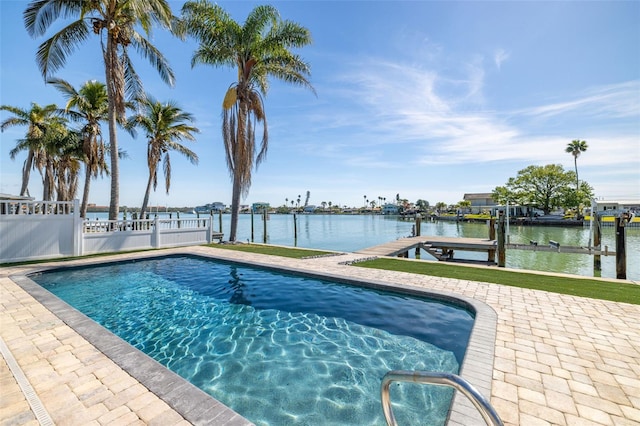 pool with a water view, boat lift, fence, and a boat dock