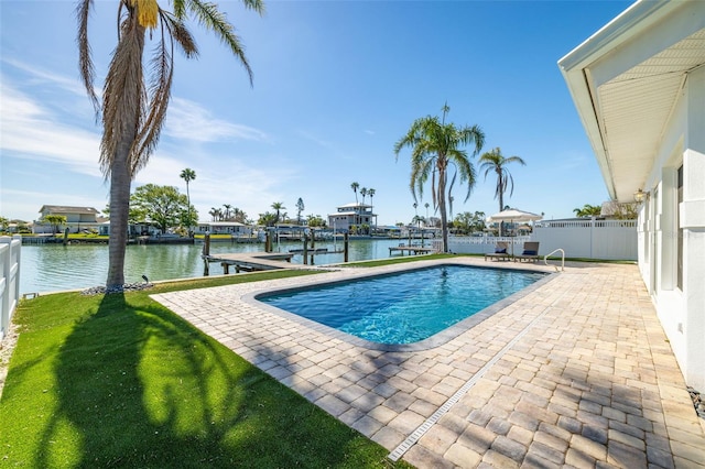 outdoor pool featuring a water view, fence, a dock, a patio, and boat lift