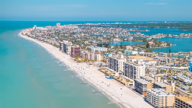 birds eye view of property featuring a water view, a view of the beach, and a city view