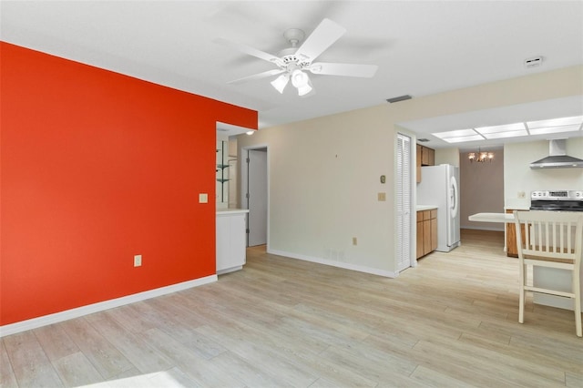 unfurnished living room featuring visible vents, ceiling fan with notable chandelier, baseboards, and light wood-type flooring