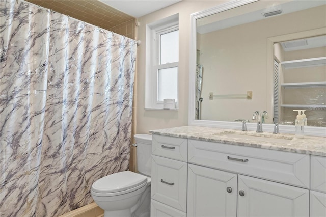 bathroom featuring visible vents, toilet, vanity, and a shower with shower curtain