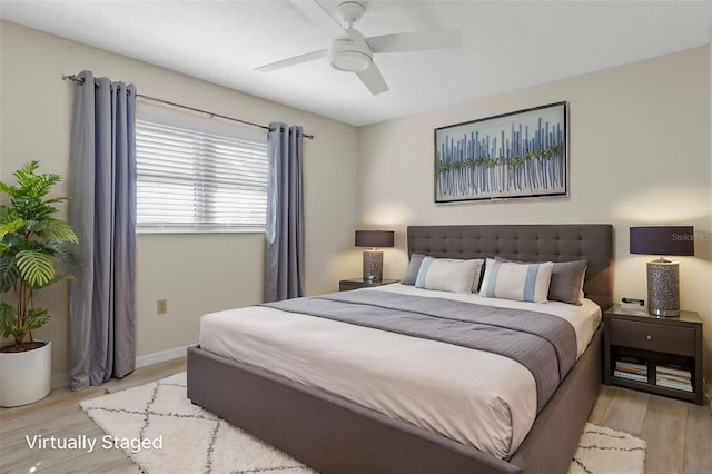 bedroom featuring light wood finished floors, baseboards, and ceiling fan