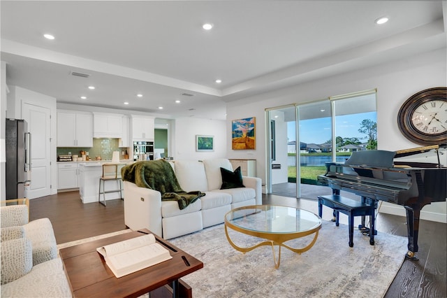 living area featuring dark wood-type flooring, visible vents, and recessed lighting