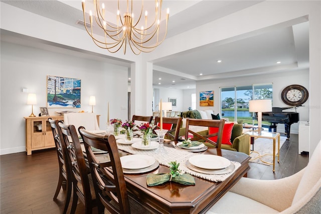dining space with baseboards, recessed lighting, a raised ceiling, dark wood-style floors, and an inviting chandelier