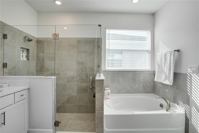 bathroom with vanity, a shower stall, recessed lighting, and a bath
