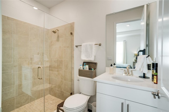 bathroom with a stall shower, toilet, and vanity