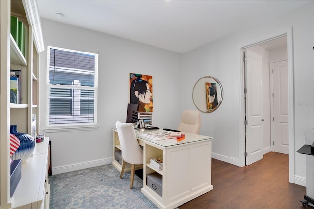 office area with baseboards and wood finished floors