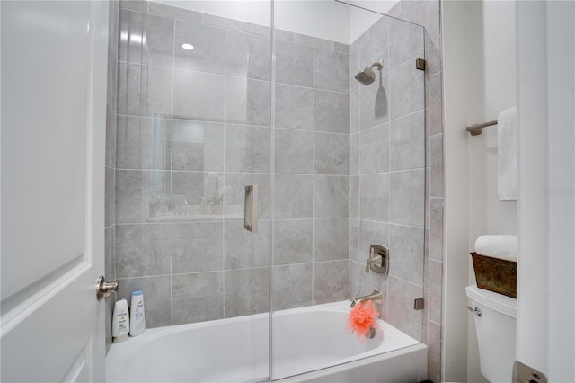 full bathroom with combined bath / shower with glass door and toilet