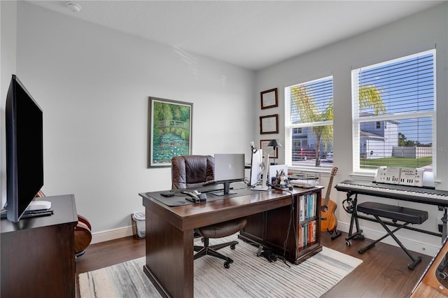 office area featuring baseboards and wood finished floors