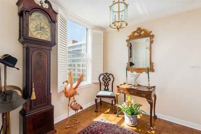 sitting room with crown molding, baseboards, and plenty of natural light