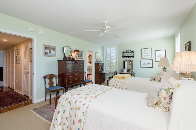 bedroom featuring baseboards, ceiling fan, and multiple windows