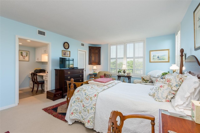 carpeted bedroom with visible vents, baseboards, and multiple windows