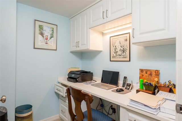 office featuring baseboards and built in desk
