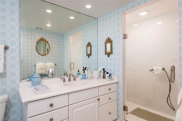 bathroom featuring visible vents, a shower stall, vanity, toilet, and recessed lighting