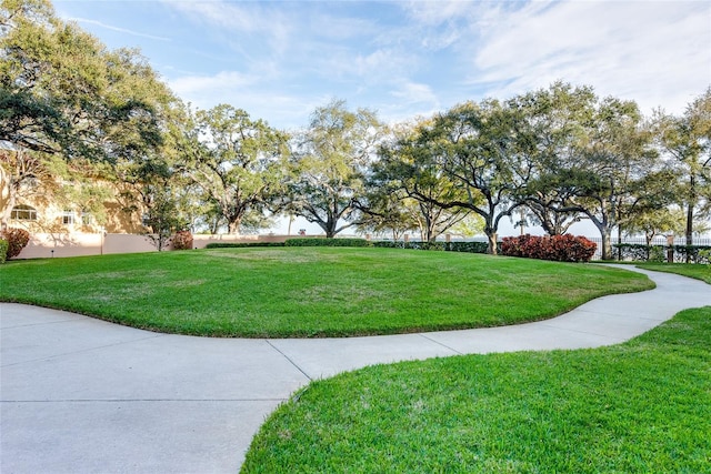 view of property's community with a lawn