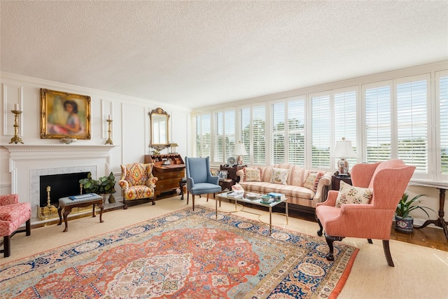 carpeted living area with a textured ceiling and a premium fireplace