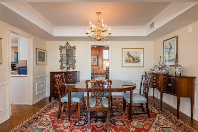 2401 S Ardson Pl Unit 503, Tampa, FL 33629 - dining space with a chandelier, a tray ceiling, ornamental molding, a decorative wall, and wainscoting