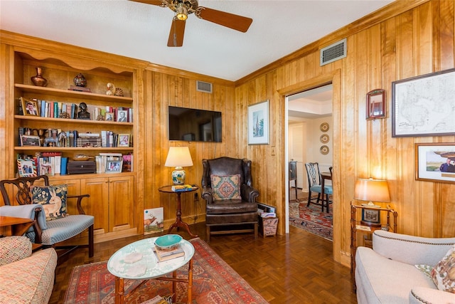 2401 S Ardson Pl Unit 503, Tampa, FL 33629 - living area featuring wood walls, a ceiling fan, and ornamental molding