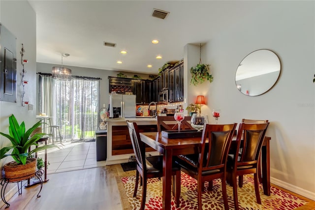 4676 66th Pl N, Pinellas Park, FL 33781 - dining room featuring visible vents, baseboards, electric panel, recessed lighting, and light wood-style flooring