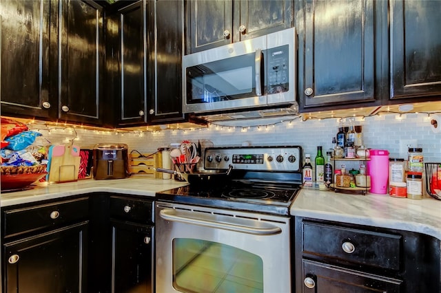 4676 66th Pl N, Pinellas Park, FL 33781 - kitchen featuring decorative backsplash, light countertops, and stainless steel appliances