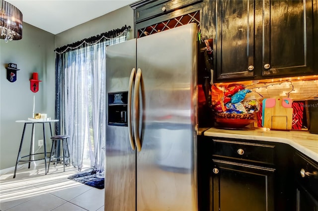 4676 66th Pl N, Pinellas Park, FL 33781 - kitchen with light tile patterned floors, light countertops, backsplash, and stainless steel refrigerator with ice dispenser
