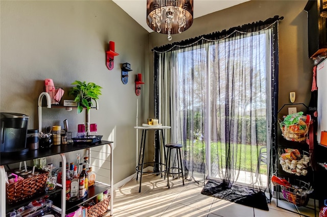 4676 66th Pl N, Pinellas Park, FL 33781 - dining space featuring tile patterned floors, an inviting chandelier, and vaulted ceiling