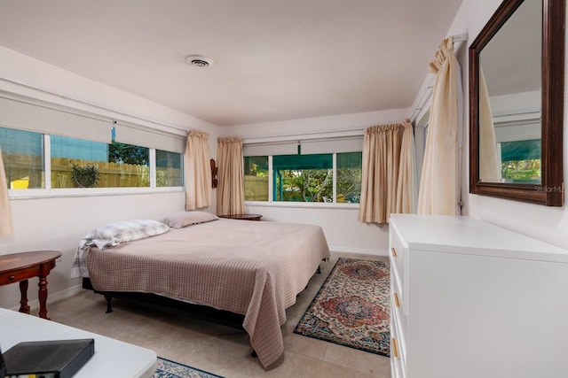 bedroom with baseboards and visible vents