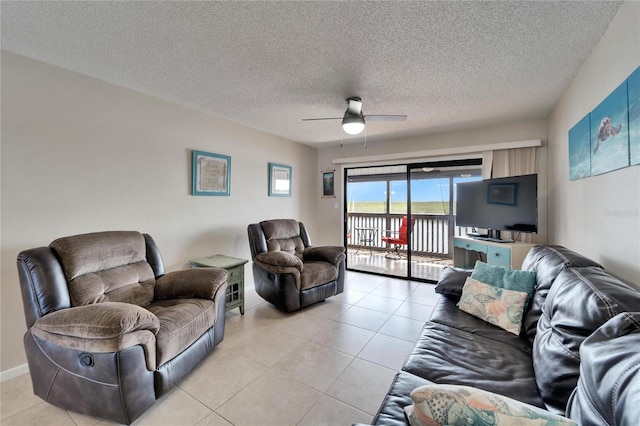 living area with light tile patterned flooring, a textured ceiling, and a ceiling fan