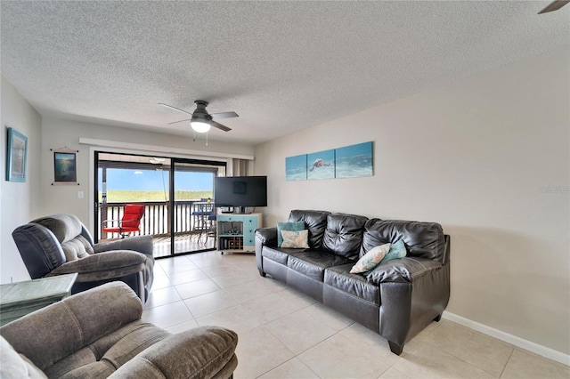 living room with baseboards, light tile patterned floors, and a ceiling fan