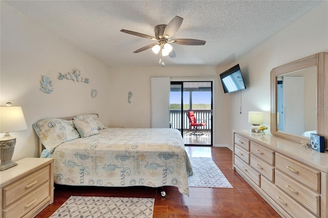 bedroom with a textured ceiling, access to exterior, ceiling fan, and dark wood-style flooring