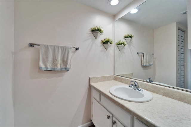 bathroom featuring visible vents, recessed lighting, and vanity