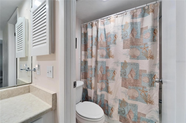 bathroom featuring toilet, a shower with shower curtain, and vanity